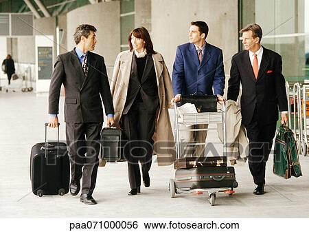 Group of business people walking in front of terminal with luggage. View Large Photo Image Stock Photograph - Group of business people walking in front of terminal with luggage.. Fotosearch