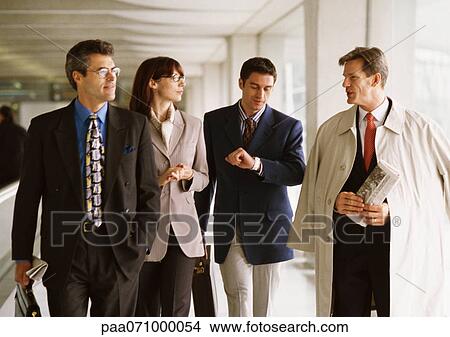 Group of business people walking together indoors, front view View Large Photo Image Picture - Group of business people walking together indoors, front view. Fotosearch
