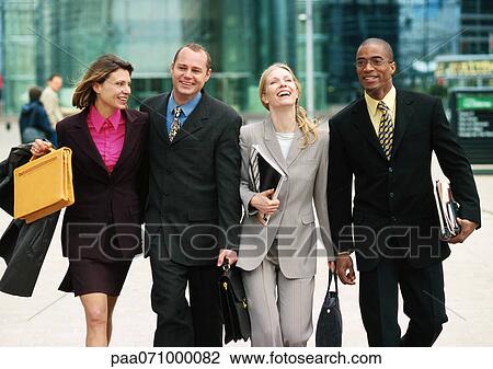Group of business people walking together outside, three quarter length, front view View Large Photo Image Stock Image - Group of business people walking together outside, three quarter length, front view. Fotosearch