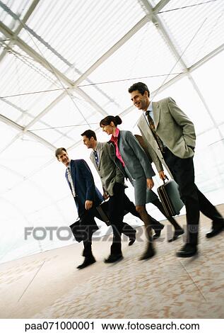 Stock Photography of Group of business people walking with briefcases ...