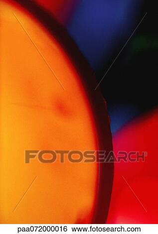 Stock Illustration - Circular light effect, orange, red and blue.. Fotosearch