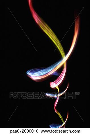 Clipart - Light effect, multi-colored trail against black background. Fotosearch