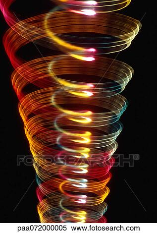 Stock Illustration - Spiraling light effect, one within the other, reds, yellows and hints of blues.. Fotosearch
