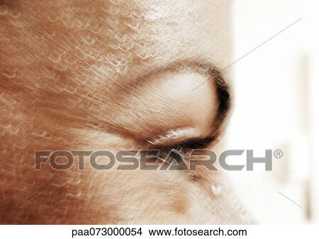 Picture - Partial view of woman's face, side view, blurred close up.. Fotosearch