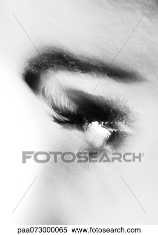 Stock Photography - Partial view of woman's face, side view, blurred black and white.. Fotosearch