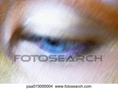 Picture - Woman's blue eye looking down, blurred close up.. Fotosearch