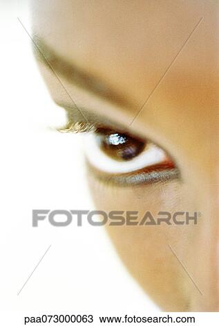 Stock Image - Woman's brown eye, blurred close up.. Fotosearch