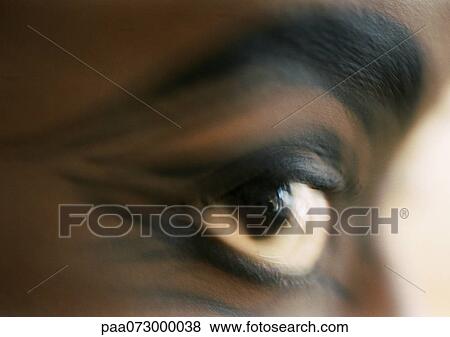 Stock Photo - Woman's brown eye, side view, blurred.. Fotosearch