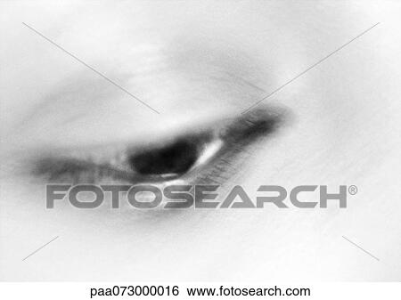 Stock Photograph - Woman's eye, blurred close up, black and white.. Fotosearch