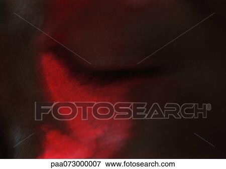 Stock Photo - Woman's eye closed, red on face, blurred close up.. Fotosearch