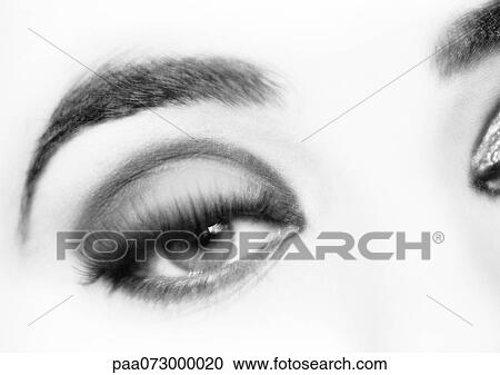 Stock Image - Woman's eye, frontal view, black and white.. Fotosearch