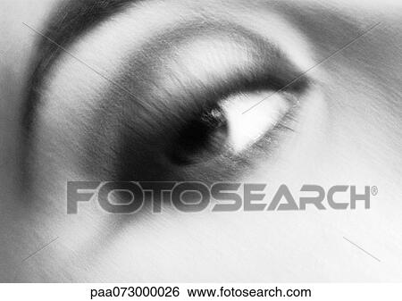 Stock Photograph - Woman's eye looking right, blurred black and white.. Fotosearch
