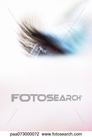 Stock Image - Woman's eyelashes, blue eye makeup, blurred close up.. Fotosearch