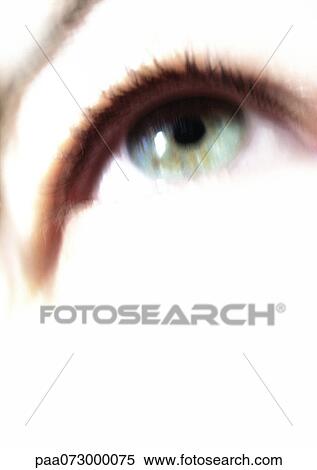 Stock Photography - Woman's green-blue eye looking up, blurred close up.. Fotosearch