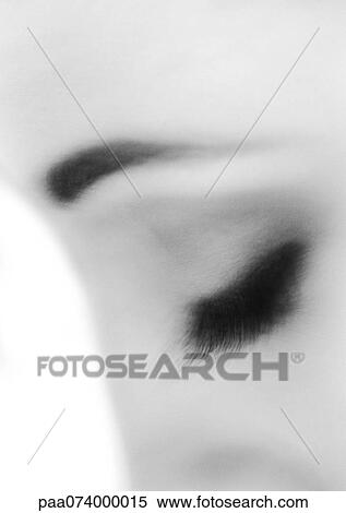 Stock Photography - Woman's closed eye, close-up, black and white, blurry.. Fotosearch