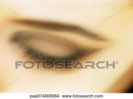 Picture - Woman's closed eye, close-up, blurry.. Fotosearch