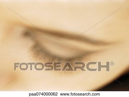 Stock Image - Woman's closed eye, close-up, high angle view, blurry.. Fotosearch