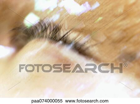 Stock Photography - Woman's closed eye, make-up on face, extreme close-up, blurry.. Fotosearch
