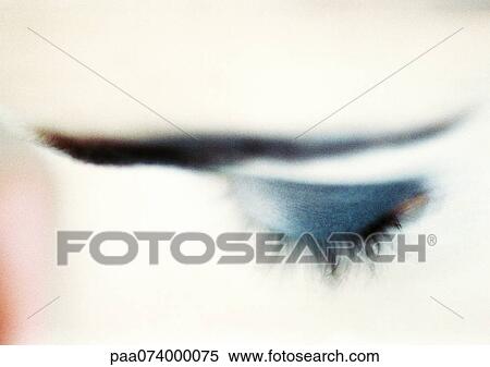 Stock Photography - Woman's closed eye with blue eye shadow, close-up, high angle view, blurry.. Fotosearch