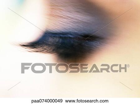 Stock Photo - Woman's closed eye with eye shadow, close-up. Fotosearch