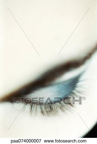 Stock Photo - Woman's closed eye with make-up, close-up. Fotosearch