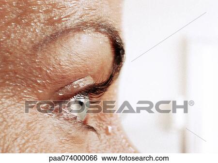 Stock Photograph - Woman's eye and wet skin, close-up, side view. Fotosearch