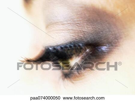 Stock Image - Woman's eye, blurry, extreme close-up. Fotosearch