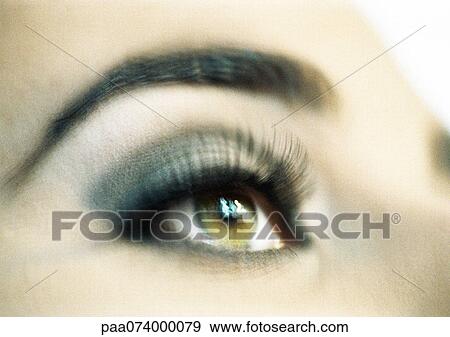 Stock Photo - Woman's hazel eye, close-up, low angle view, blurry.. Fotosearch