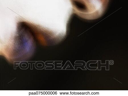 Stock Photograph - Woman wearing dark lipstick and white face make-up, close up of mouth, side view, blurred.. Fotosearch