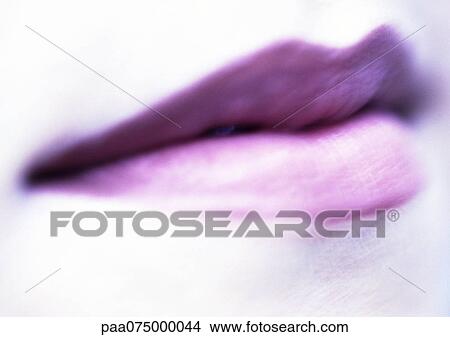 Woman wearing purple lipstick, extreme close up, blurred. View Large Photo Image Picture - Woman wearing purple lipstick, extreme close up, blurred.. Fotosearch