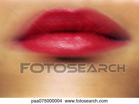 Picture - Woman wearing red lipstick, close up of mouth, blurred.. Fotosearch