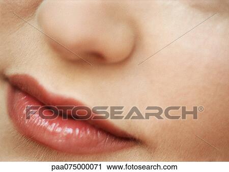 Stock Image - Woman's nose and mouth, close up.. Fotosearch