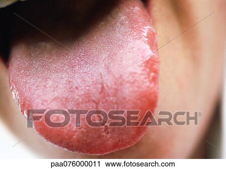 Stock Image - Close up of woman sticking tongue out.. Fotosearch