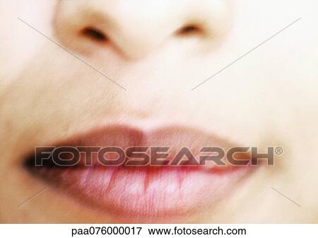 Stock Photo - Close up of woman's face, partial view, blurred. Fotosearch