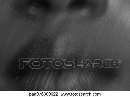 Stock Image - Close up of woman's mouth, black and white, blurry.. Fotosearch