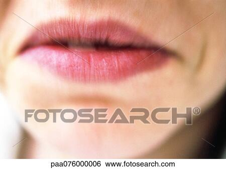 Stock Photograph - Close up of woman's mouth frowning, blurry.. Fotosearch