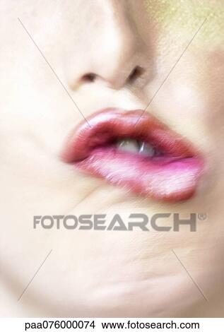 Picture - Close up of woman's mouth making expression, blurry.. Fotosearch