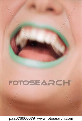 Close up of woman's mouth open and smiling with green lipstick, blurred View Large Photo Image Stock Photo - Close up of woman's mouth open and smiling with green lipstick, blurred. Fotosearch