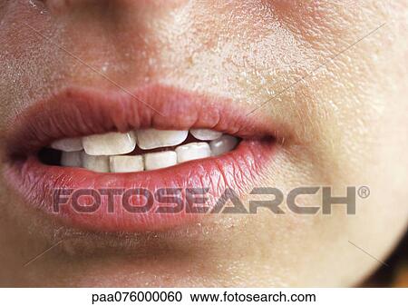 Stock Image - Close up of woman's mouth slightly open.. Fotosearch