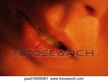 Stock Image - Close up of woman's mouth slightly open.. Fotosearch