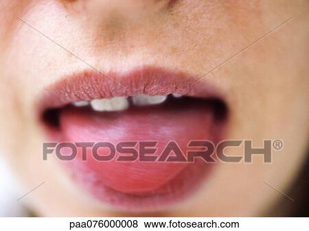 Stock Photo - Close up of woman's mouth with tongue sticking out.. Fotosearch