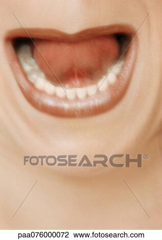 Stock Image - Close up of woman's open mouth, blurry.. Fotosearch