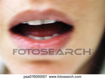 Stock Photo - Close up of woman's open mouth, blurry.. Fotosearch