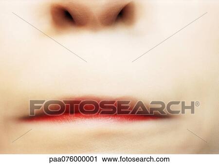 Stock Image - Close up of woman's pursed lips, blurry.. Fotosearch