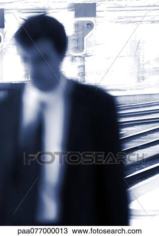Businessman standing on platform, blurred View Large Photo Image Stock Image - Businessman standing on platform, blurred. Fotosearch