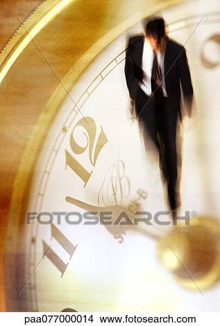 Businessman walking on clock, montage View Large Photo Image Picture - Businessman walking on clock, montage. Fotosearch