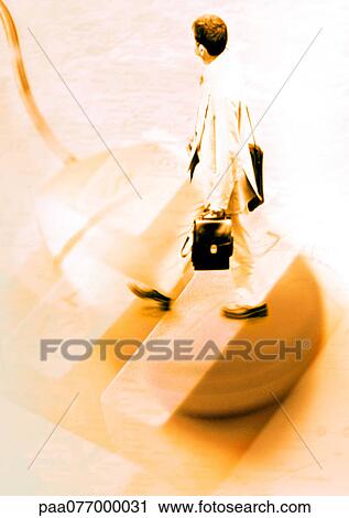 Stock Image - Businessman walking on crosswalk, superimposed on computer mouse.. Fotosearch