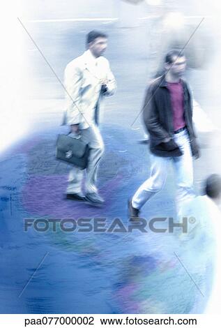 Stock Image - Businessmen walking on globe, montage. Fotosearch