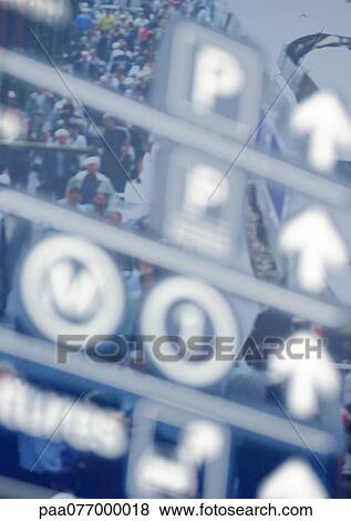 Directional signs superimposed over crowd of people. View Large Photo Image Stock Photo - Directional signs superimposed over crowd of people.. Fotosearch