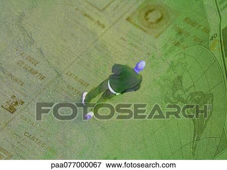 Man, high angle view, walking on newspaper with globe, montage View Large Photo Image Stock Photo - Man, high angle view, walking on newspaper with globe, montage. Fotosearch